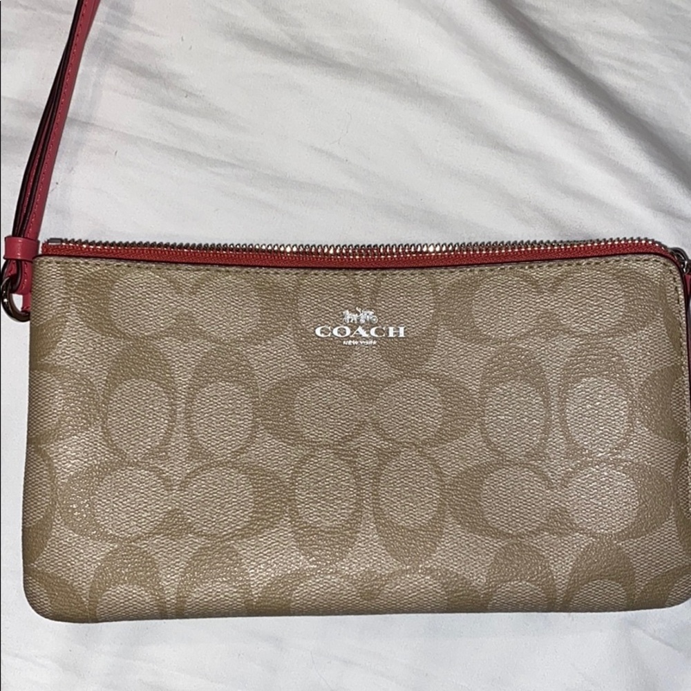 Authentic Coach wristlet with pink accents